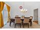 Bright dining room with a chandelier, large window, and classic details at 2053 Stillwood Dr, Youngsville, NC 27596
