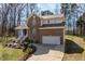 Two-story brick home with a driveway, two-car garage, and a well-maintained front lawn at 2053 Stillwood Dr, Youngsville, NC 27596