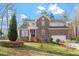 Charming brick two-story home with manicured lawn and attached two-car garage at 2053 Stillwood Dr, Youngsville, NC 27596