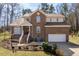 Charming brick two-story home with manicured lawn and attached two-car garage at 2053 Stillwood Dr, Youngsville, NC 27596