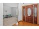 Bright foyer with hardwood floors, a decorative front door, and views into the formal living area at 2053 Stillwood Dr, Youngsville, NC 27596