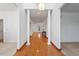 Inviting hallway with gleaming hardwood floors, decorative columns, and abundant natural light at 2053 Stillwood Dr, Youngsville, NC 27596
