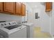 Functional laundry room with washer, dryer, and storage cabinets at 2053 Stillwood Dr, Youngsville, NC 27596