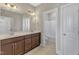 Bright bathroom with a double sink vanity, tiled floors, and separate toilet room with shower and tub at 215 Mystic Pine Pl, Apex, NC 27539