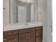 Bathroom with a vanity featuring dark wood cabinets, white countertop, and chrome fixtures at 215 Mystic Pine Pl, Apex, NC 27539