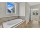 Relaxing bathroom with soaking tub and natural light at 215 Mystic Pine Pl, Apex, NC 27539