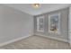 Neutral bedroom with ample natural light from two large windows and neutral carpeting at 215 Mystic Pine Pl, Apex, NC 27539