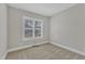 Cozy bedroom with carpeted floor and a window providing natural light at 215 Mystic Pine Pl, Apex, NC 27539