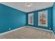 Bedroom painted with blue walls and carpeted flooring, natural light through two windows at 215 Mystic Pine Pl, Apex, NC 27539