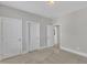 Neutral bedroom featuring multiple doors, carpeted flooring and painted walls at 215 Mystic Pine Pl, Apex, NC 27539