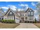 Beautiful two-story home with a manicured lawn and a two-car garage on a sunny day at 215 Mystic Pine Pl, Apex, NC 27539