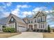 Beautiful two-story home with a manicured lawn and a two-car garage on a sunny day at 215 Mystic Pine Pl, Apex, NC 27539