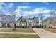 Charming two-story home featuring a well-manicured lawn, a long driveway, and mature landscaping at 215 Mystic Pine Pl, Apex, NC 27539