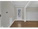 Bright foyer featuring hardwood floors, white trim, and a view of the front door at 215 Mystic Pine Pl, Apex, NC 27539