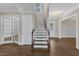 Welcoming foyer with hardwood floors, staircase, and French doors leading to another room at 215 Mystic Pine Pl, Apex, NC 27539