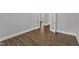 Hallway featuring hardwood floors and an open doorway leading to another room at 215 Mystic Pine Pl, Apex, NC 27539