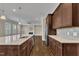Bright and open kitchen design featuring an island, stainless steel appliances, and seamless flow to living area at 215 Mystic Pine Pl, Apex, NC 27539