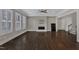 Spacious living room with hardwood floors, a modern fireplace, and plenty of natural light at 215 Mystic Pine Pl, Apex, NC 27539