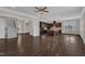Open-concept living area with hardwood floors, staircase access, and view into the kitchen at 215 Mystic Pine Pl, Apex, NC 27539