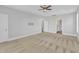 Expansive main bedroom with tray ceilings, fan, multiple doors, and neutral carpeting at 215 Mystic Pine Pl, Apex, NC 27539