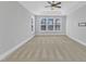 Spacious primary bedroom featuring large windows and neutral carpeting at 215 Mystic Pine Pl, Apex, NC 27539