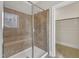 Tiled shower with glass door and bench at 215 Mystic Pine Pl, Apex, NC 27539