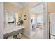 Bright bathroom with white vanity, a large mirror, tile flooring, and tub at 2308 Carriage Oaks Dr, Raleigh, NC 27614
