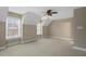Large bedroom featuring two windows and a ceiling fan at 2308 Carriage Oaks Dr, Raleigh, NC 27614