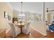 Bright dining area with a round table, plush chairs, hardwood floors, and views of the outdoor space at 2308 Carriage Oaks Dr, Raleigh, NC 27614