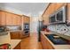 Well-equipped kitchen with wooden cabinetry, stainless steel appliances, and a functional layout at 2308 Carriage Oaks Dr, Raleigh, NC 27614