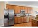 Kitchen featuring stainless steel appliances, wood cabinets, and a functional design at 2308 Carriage Oaks Dr, Raleigh, NC 27614
