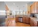 Spacious kitchen with stainless steel appliances, wood cabinetry, and seamless transition to dining area at 2308 Carriage Oaks Dr, Raleigh, NC 27614