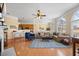 Bright living room with an open layout, hardwood floors, and view of kitchen at 2308 Carriage Oaks Dr, Raleigh, NC 27614