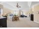 Bright main bedroom features a tray ceiling, ceiling fan and sitting area by a bank of windows at 2308 Carriage Oaks Dr, Raleigh, NC 27614