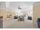 Bright main bedroom features a tray ceiling, ceiling fan and sitting area by a bank of windows at 2308 Carriage Oaks Dr, Raleigh, NC 27614