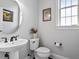 Powder room featuring a pedestal sink and natural light at 2554 Club Level Dr, Apex, NC 27523