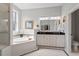 Bathroom with soaking tub, separate shower and double vanity at 2554 Club Level Dr, Apex, NC 27523