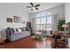 Bedroom featuring hardwood floors, a daybed, large window, and natural light at 2554 Club Level Dr, Apex, NC 27523
