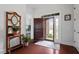 Bright and airy foyer featuring hardwood floors, coat rack and a view of the front door at 2554 Club Level Dr, Apex, NC 27523