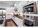 Modern kitchen features stainless steel appliances, granite countertops, and white cabinets at 2554 Club Level Dr, Apex, NC 27523