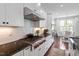 Bright kitchen with stainless steel gas range, granite countertops, and white cabinetry at 2554 Club Level Dr, Apex, NC 27523