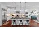 Well-equipped kitchen with center island, granite counters, stainless appliances, and bar seating at 2554 Club Level Dr, Apex, NC 27523