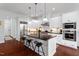 Gourmet kitchen boasts a large island, stainless steel appliances, and stylish pendant lighting at 2554 Club Level Dr, Apex, NC 27523