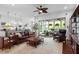 Open-concept living room with hardwood floors and sliding glass doors leading to a screened porch at 2554 Club Level Dr, Apex, NC 27523