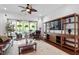 Open-concept living room with hardwood floors and sliding glass doors leading to a screened porch at 2554 Club Level Dr, Apex, NC 27523