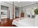 Spacious bedroom with a four-poster bed, hardwood floors, and ensuite bath at 2554 Club Level Dr, Apex, NC 27523