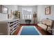Office area with hardwood flooring, large window with shutter, and Singer sewing machine at 2554 Club Level Dr, Apex, NC 27523