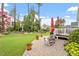 Relaxing patio area with chairs, brick pavers, manicured yard and mature landscaping at 2554 Club Level Dr, Apex, NC 27523