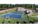 Aerial view of community tennis courts, playground, swimming pool, and clubhouse at 2554 Club Level Dr, Apex, NC 27523