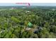 Aerial view showcasing the neighborhood, lush green trees, and the skyline of downtown Durham at 2603 Vineyard St, Durham, NC 27707